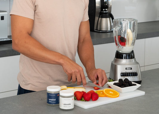 Elevate and Unwind next to a chopping board of fruit