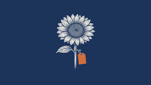 Engraving of a sunflower head with a blank orange tag on navy